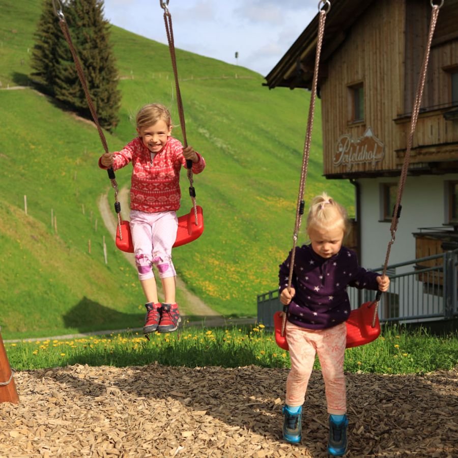 Kinder beim Schaukeln im Familienurlaub in Saalbach
