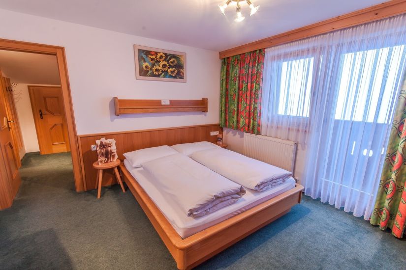 Doppelzimmer im Bauernhaus am Perfeldhof mit Doppelbett, Balkon und Blick Richtung Hinterglemm in Saalbach Hinterglemm