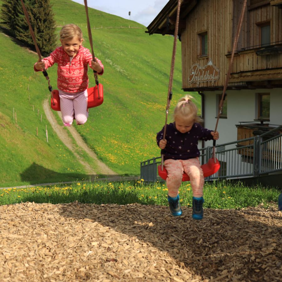 Kinder beim Schaukeln im Familienurlaub in Saalbach